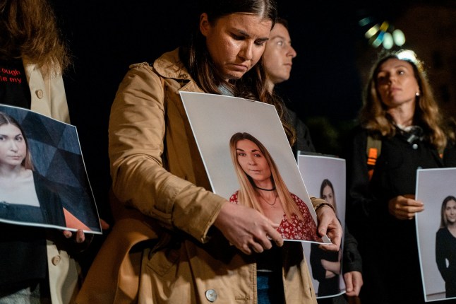 KYIV, UKRAINE - OCTOBER 11: People hold portraits of Ukrainian journalist Victoria Roshchyna during a commemoration for Roshchyna who died in Russian captivity, on Maidan Nezalezhnosti (Independence Square) on October 11, 2024 in Kyiv, Ukraine. Victoria Roshchyna disappeared on August 3, 2023 in the temporarily occupied territories while performing work duties. It became known about the death of the journalist in Russian captivity on October 10. She was on the lists for POW exchange and was supposed to return to Ukraine but died during the staging from Taganrog to Moscow. (Photo by Tanya Dzafarowa/Suspilne Ukraine/JSC "UA:PBC"/Global Images Ukraine via Getty Images)