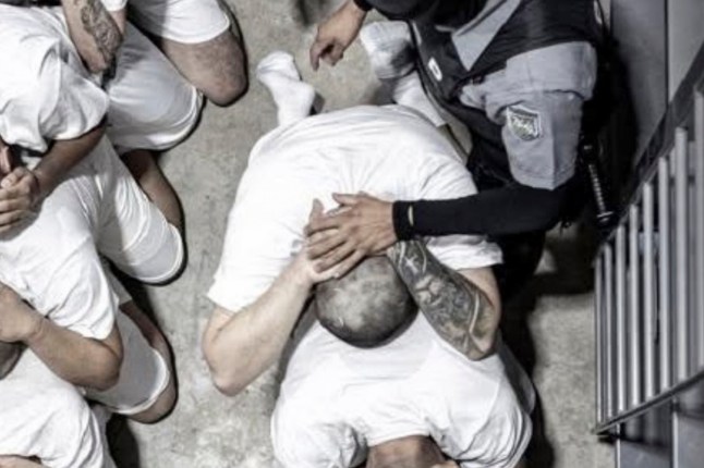 In this undated photo provided by the U.S. District Court for the District of Maryland in April 2025, a man identified by Jennifer Vasquez Sura as her husband, Kilmar Abrego Garcia, is forced to sit with other prisoners by guards in the Terrorism Confinement Center in Tecoluca, El Salvador. (U.S. District Court for the District of Maryland via AP)
