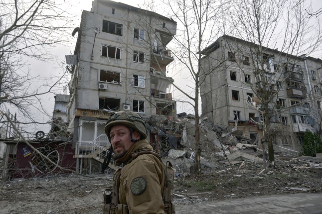 POKROVSK, UKRAINE - APRIL 8: A soldier walks through the city by destroyed residential buildings which is now almost on the front line on April 8, 2025 in Pokrovsk, Ukraine. Civilian life in a city that is now almost on the front line with entry and exit from the city controlled by Russian FPV drones. There is no way for police or volunteers to enter the city. (Photo by Kostiantyn Liberov/Libkos/Getty Images)