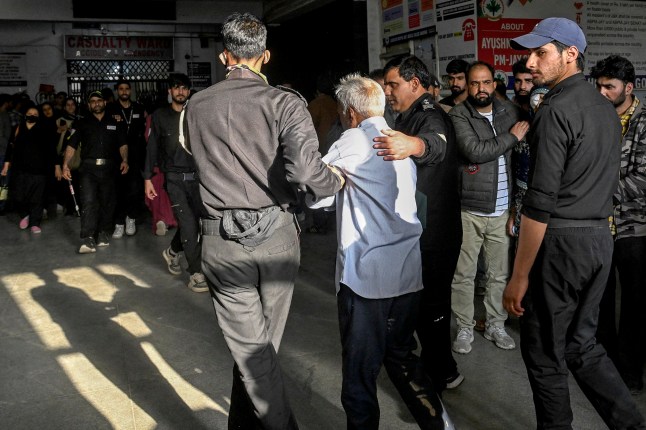 Paramedics carry an injured tourist at a hospital in Anantnag, south of Srinagar, on April 22, 2025, following an attack. Gunmen in Indian-administered Kashmir opened fire on a group of tourists on April 22, with the chief minister saying the "inhuman" attack was one of the worst targeting civilians for years. At least five people were killed, a senior politician in the Himalayan region said. (Photo by Tauseef MUSTAFA / AFP) (Photo by TAUSEEF MUSTAFA/AFP via Getty Images)
