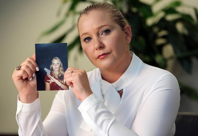 Virginia Giuffre holding photo.