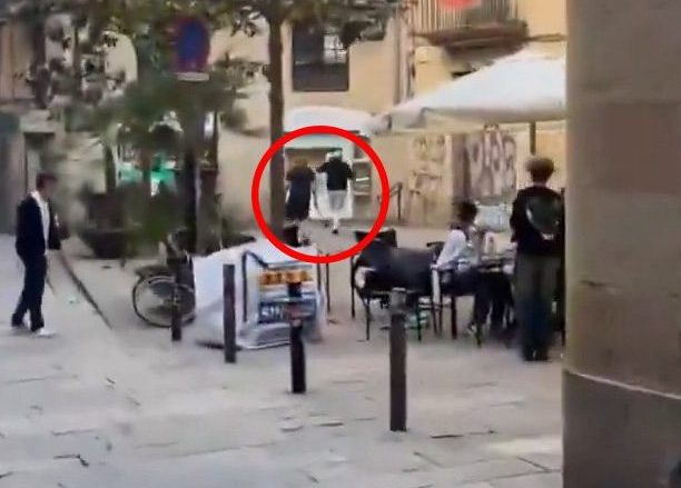 GRABS TAKEN FROM X/ XabiJuez IN A VIDEO THAT HAS SICE BEEN REMOVED A clip posted on social media shows the armed suspect charging at people while running through the streets of Placa de Sant Jaume, as loud screams were heard in the background.