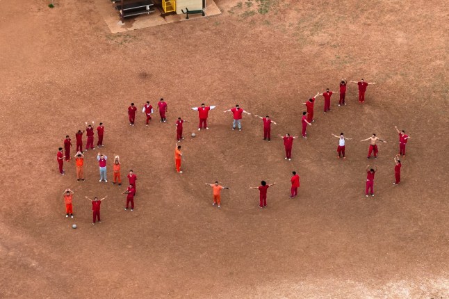 A drone view of detainees forming the letters SOS with their bodies in the courtyard at the Bluebonnet Detention Facility, where Venezuelans at the center of a U.S. Supreme Court ruling are held, in Anson, Texas, U.S. April 28, 2025. REUTERS/Paul Ratje TPX IMAGES OF THE DAY