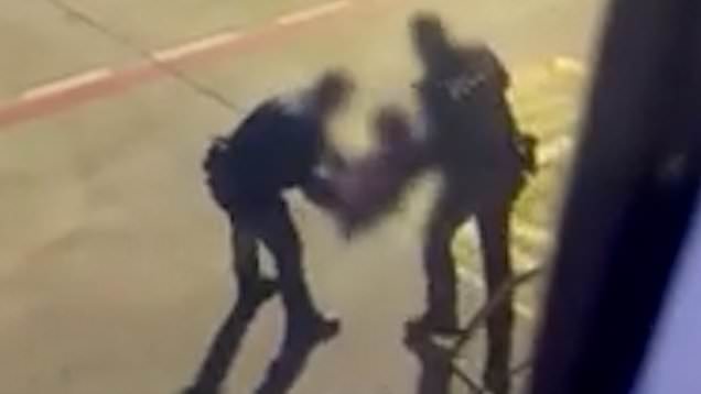 Footage shared with the MEN shows a woman being carried off the plane by officer