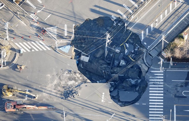 An aerial view shows a large sinkhole that formed when a sinkhole that swallowed a truck and a man believed to be its driver at an intersection in Yashio, formed on January 28, 2025, and another that formed during rescue operations, merged, near Tokyo, Japan January 30, 2025, in this photo taken by Kyodo. Kyodo/via REUTERS ATTENTION EDITORS - THIS IMAGE HAS BEEN SUPPLIED BY A THIRD PARTY. MANDATORY CREDIT. JAPAN OUT. NO COMMERCIAL OR EDITORIAL SALES IN JAPAN.
