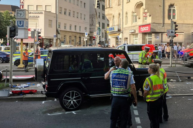 Police work at the scene where a vehicle collided into a group of people in Stuttgart, Germany, on Friday, May 2, 2025. (Marco Krefting/dpa via AP)
